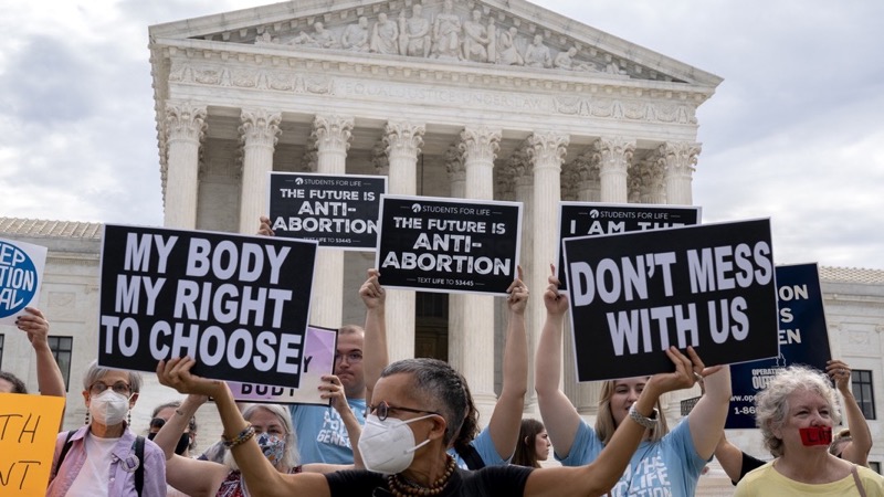 Pro-choice activists hold signs outside the U.S. Supreme Court in Washington, D.C., U.S., on Monday, Oct. 4, 2021. The court's conservative wing to offers a menu of opportunities exploit its 6-3 majority, and give Republicans the type of payoff they envisioned when they pushed through her Senate confirmation just before the 2020 election. Photographer: Stefani Reynolds/Bloomberg