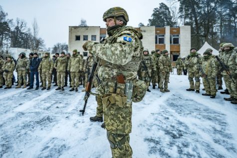 A military trainer with Ukraine’s 112th Territorial Defense Brigade works with civilians during a military exercise outside Kyiv on February 5. The Ministry of Defense created defense brigades in Ukraine’s main cities because of the risk of invasion by Russia, which is amassing troops at the border. 
